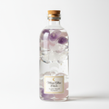 Crystal-infused moon water bottle with healing crystals on white background