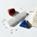 Red jasper white selenite and blue lapis lazuli crystals on white background